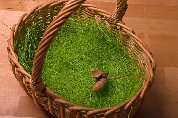 stock image Basket, artificial grass and acorn