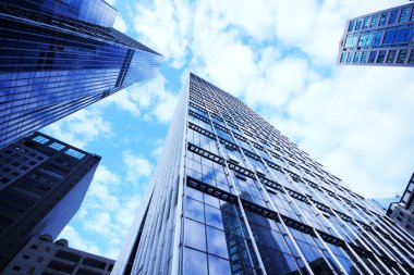 Modern glass silhouettes of skyscrapers clipart