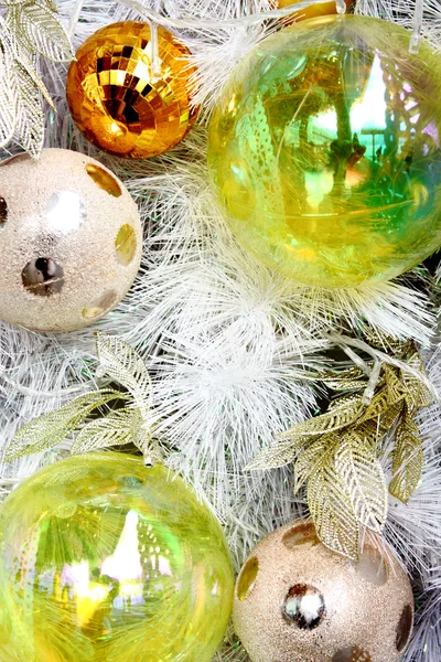 Christmas balls on white feathers — Stock Photo, Image