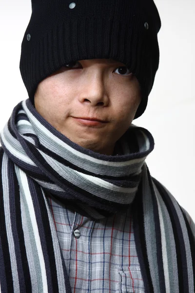 A happy smiling man wearing a hat and scarf posing against white — Stock Photo, Image
