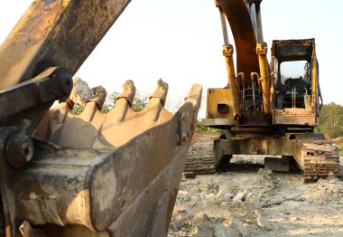 Heavy Duty Construction Equipment Parked at Worksite clipart