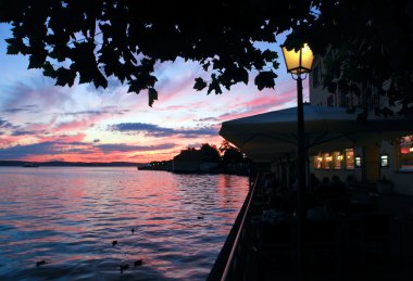 Relaxing on the seaside promenade of Meersburg clipart