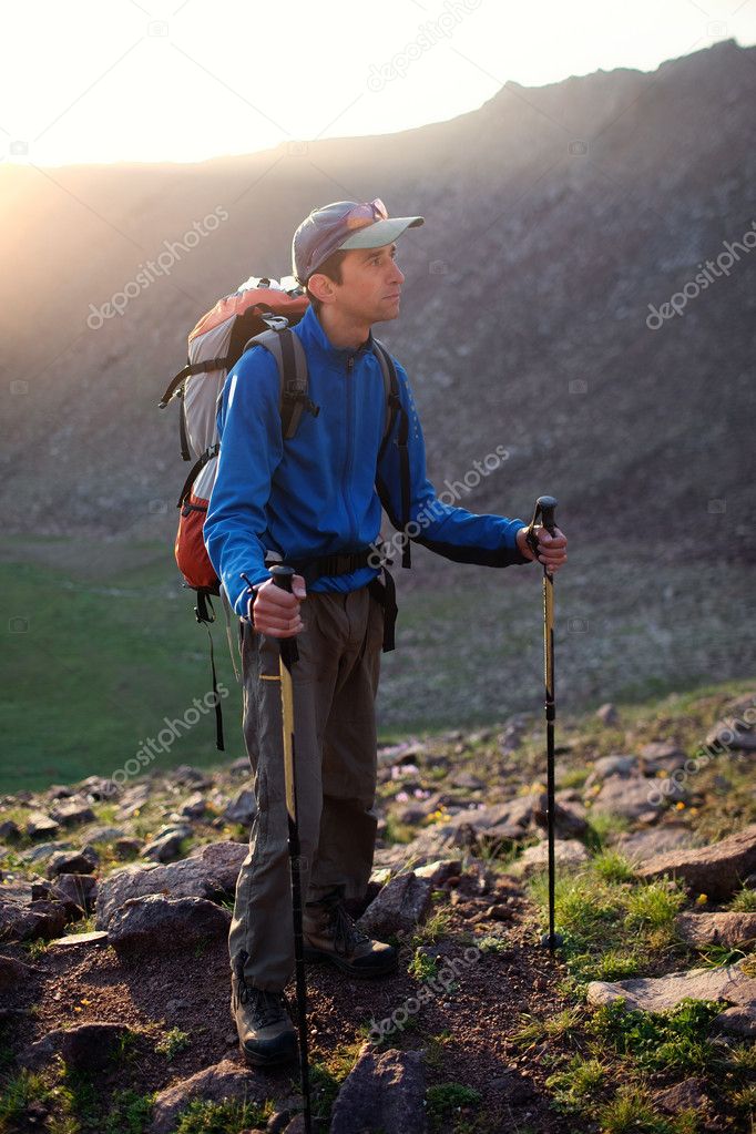 Backpaker at dawn in the mountains