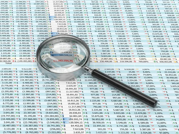 Magnifying glass on a spreadsheet — Stock Photo, Image