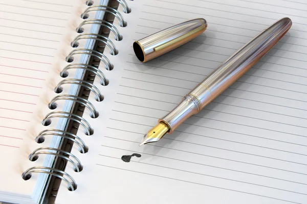 Metal fountain pen on notebook — Stock Photo, Image