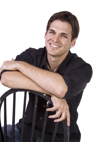 Handsome and stylish model sitting on chair — Stock Photo, Image