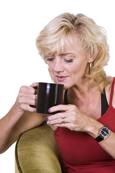 Vrouw zitten op een stoel drinken koffie — Stockfoto