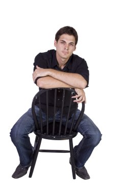 Handsome and stylish model sitting on chair clipart