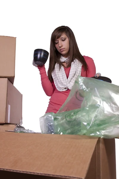 Young girl packing up and moving - isolated — Stock Photo, Image