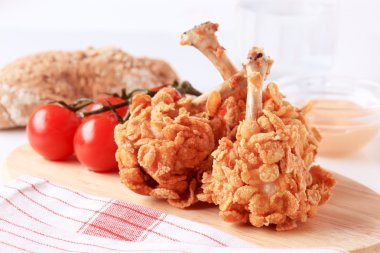 Chicken drumsticks coated with corn flakes clipart