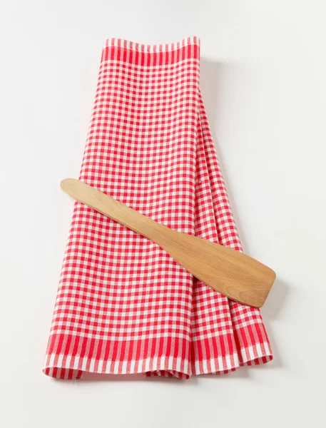 Tea towel and wooden spatula — Stock Photo, Image