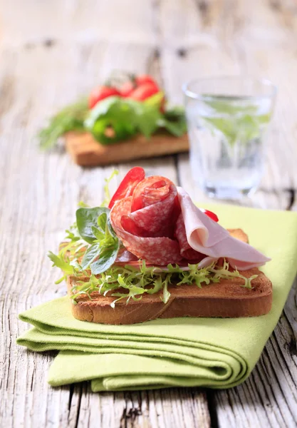 Ham and salami on toast — Stock Photo, Image