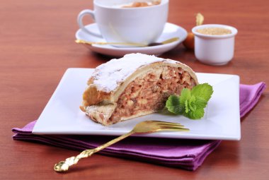 Slice of apple strudel and a cup of coffee clipart