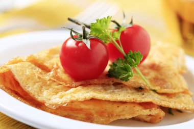 Egg omelets and fresh red tomatoes - detail clipart