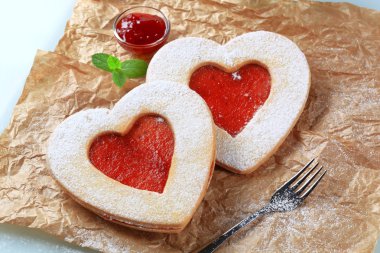 Heart shaped shortbread cookies with jam filling clipart