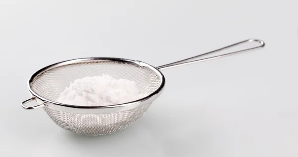 Powdered sugar in a sieve — Stock Photo, Image