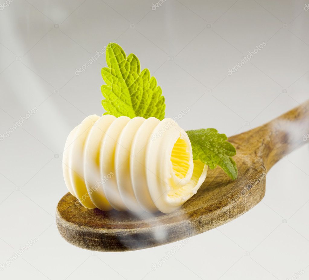 Butter curl on a wooden spoon