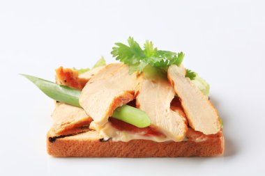 Slices of grillled turkey breast on toast clipart