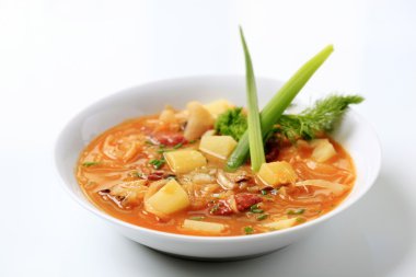 Cabbage soup with potatoes and sausage - studio clipart