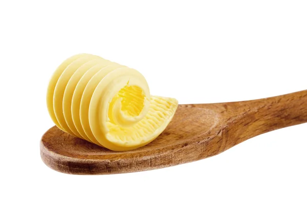 Boucle de beurre sur une cuillère en bois — Photo