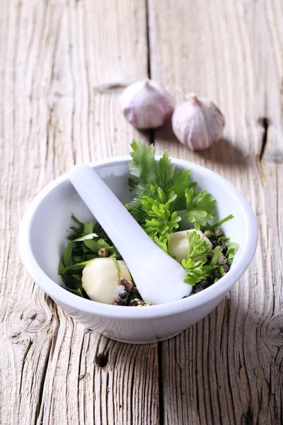 Mortar and pestle with ingredients — Stock Photo, Image