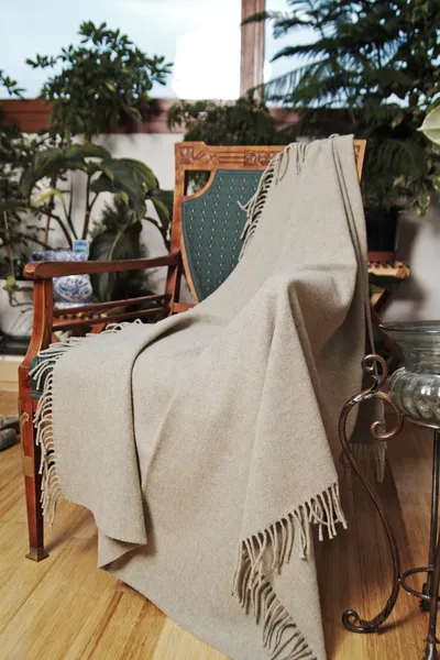 Throw draped over an antique chair — Stock Photo, Image