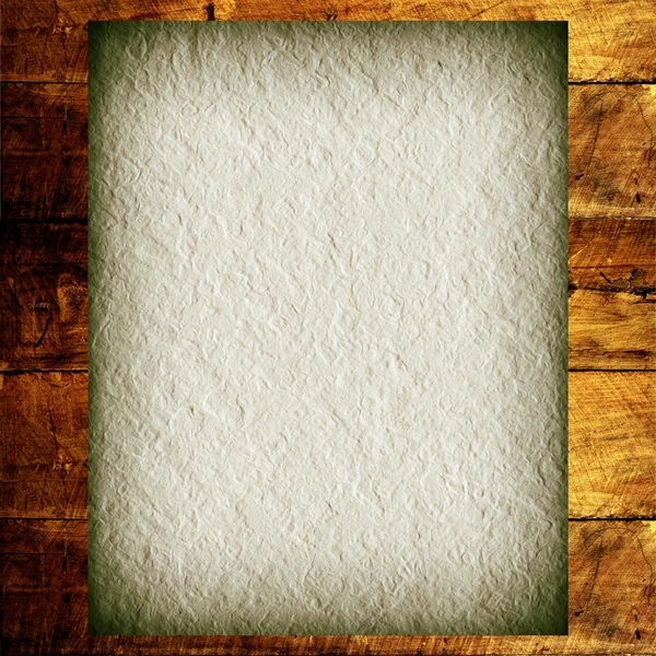 Old paper on a wooden background — Stock Photo, Image