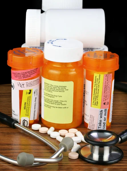 Medications with warnings and stethoscope-low key image and copy — Stock Photo, Image