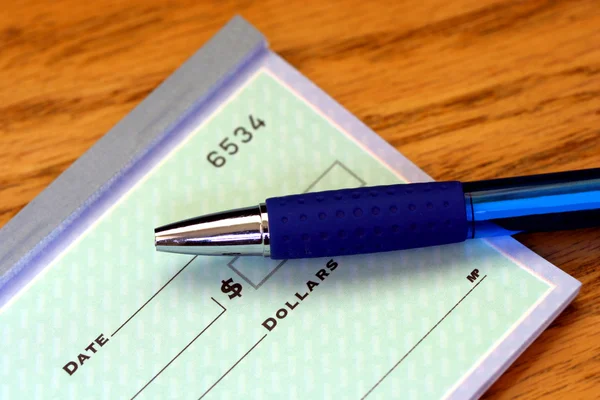 Portion of check with pen — Stock Photo, Image