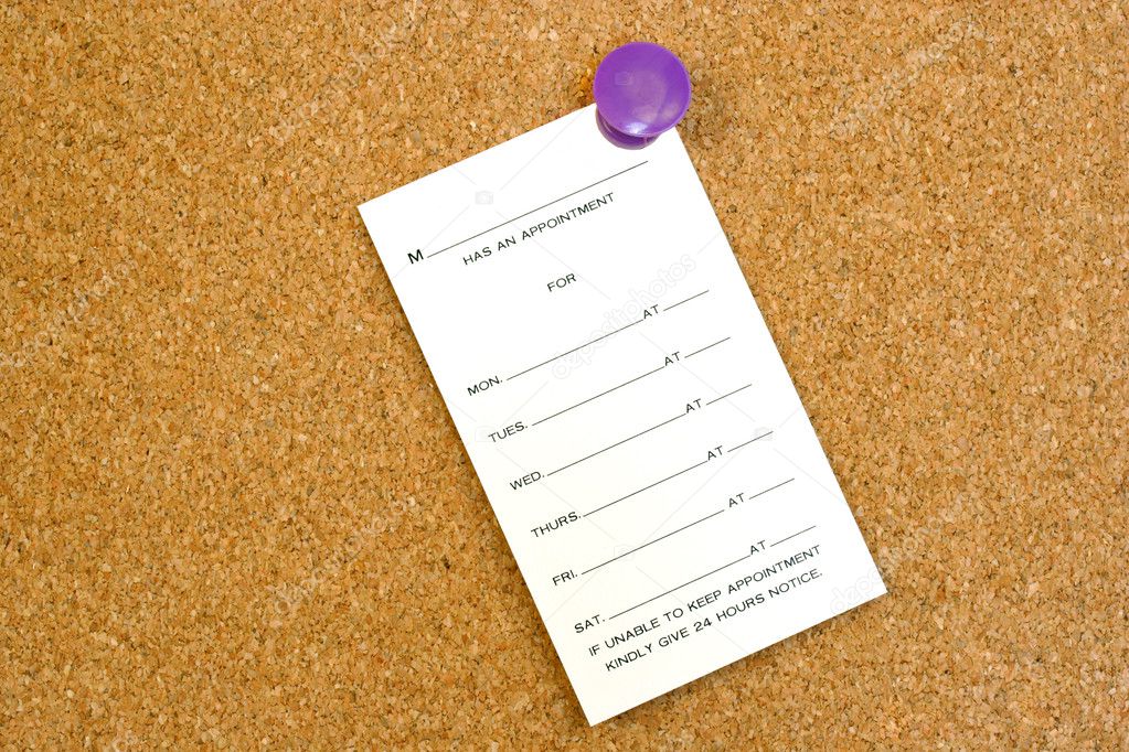 Blank appointment card on cork board.