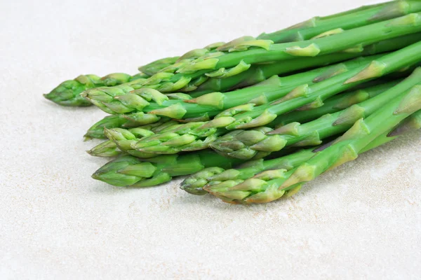Asparagus on counter, close up with copy space. — Stock Photo, Image