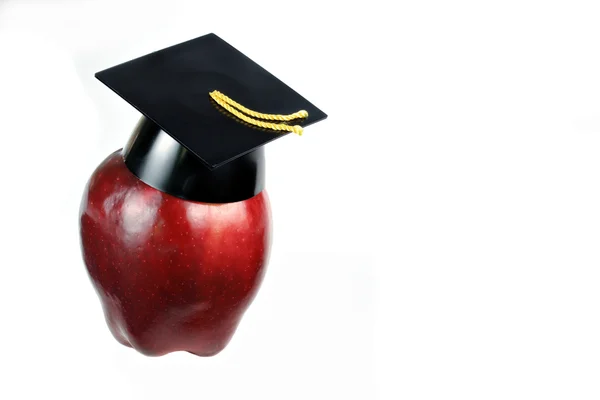 Ukończeniu graduacyjnej na na białym tle z miejsca kopiowania apple — Zdjęcie stockowe