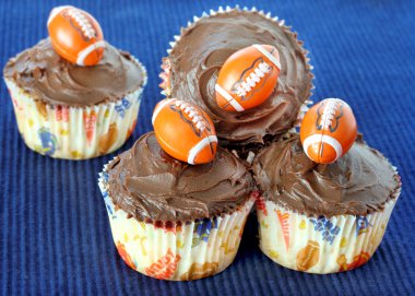 Chocolate cupcakes with footballs clipart