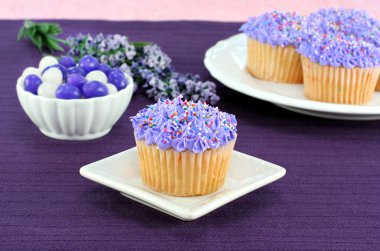 Pretty purple cupcakes and jelly beans for Easter clipart