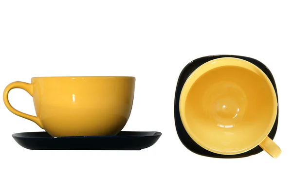 Large yellow cup and black saucer, top view and side view, isolated on whit — Stock Photo, Image