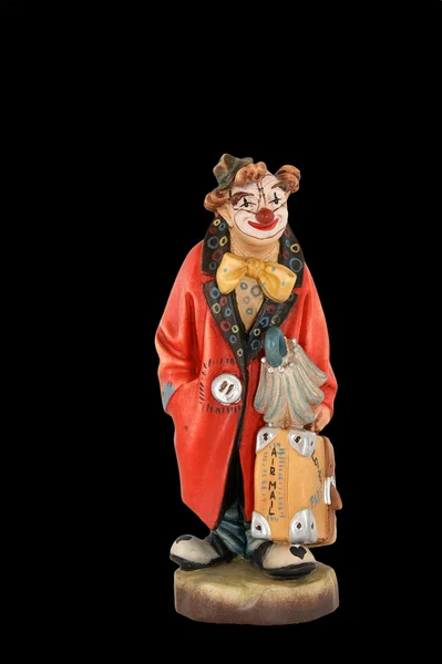The isolated figurine of the clown with a large suitcase — Stock Photo, Image