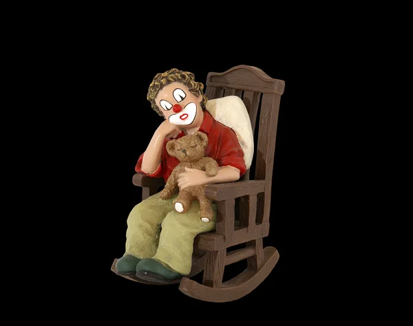 Het geïsoleerde beeldje van de clown in een schommelstoel — Stockfoto