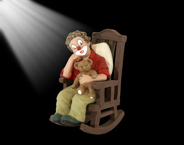 Het geïsoleerde beeldje van de clown in een schommelstoel — Stockfoto