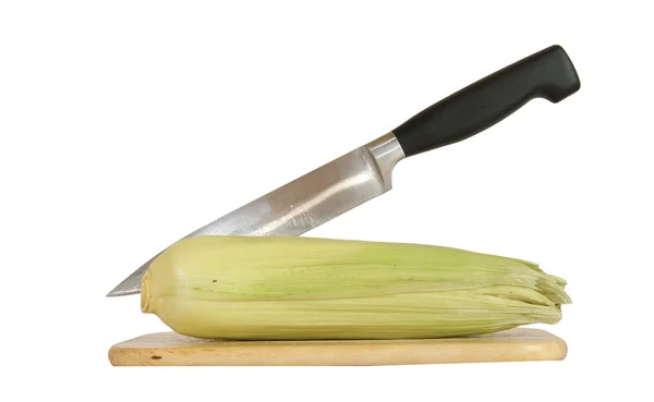 stock image Still life with a natural corn cob with a knife and cutting board. In isolation