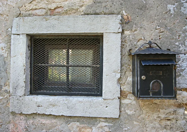 Window of an apartment house with bars and a mailbox, old town of Porec, Is — Stock Photo, Image