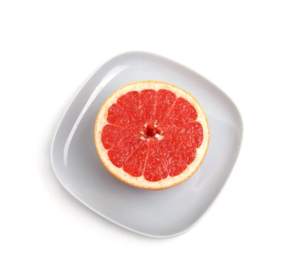 Zralý červený grapefruit. nakrájené ovoce na modrou desku — Stock fotografie
