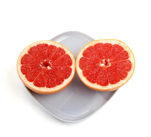 Rijp rood grapefruit. de gesneden fruit op een blauw bord — Stockfoto