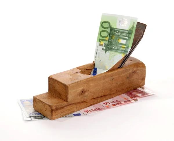 Stock image Work and earn. Old wood the planer and paper banknotes