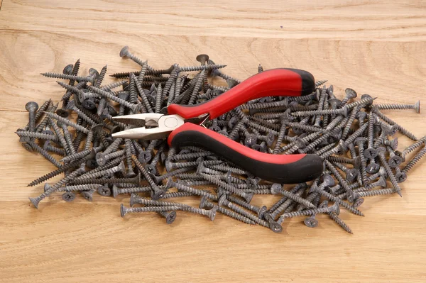 A pile of old screws and pliers — Stock Photo, Image