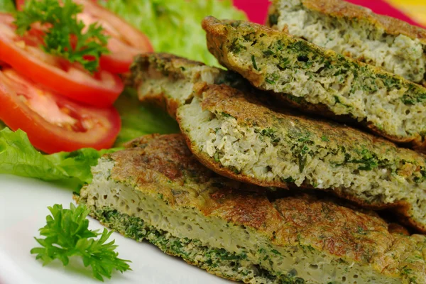 stock image Omelette with herbs on white plate with parsley, lettuce and tomato slices (Selective Focus)