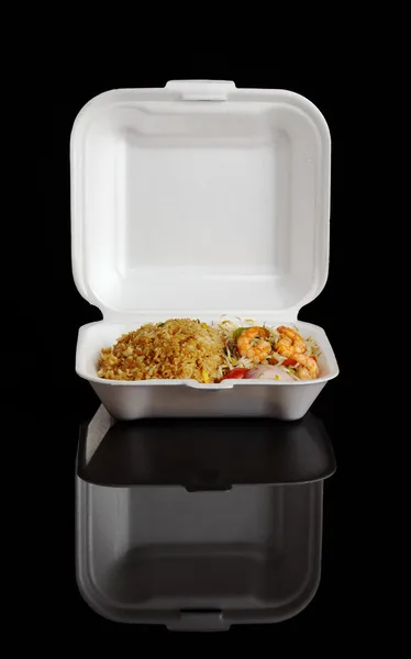 stock image Chinese take-away food: Fried rice with king prawns and vegetables in a styrofoam box photographed on black