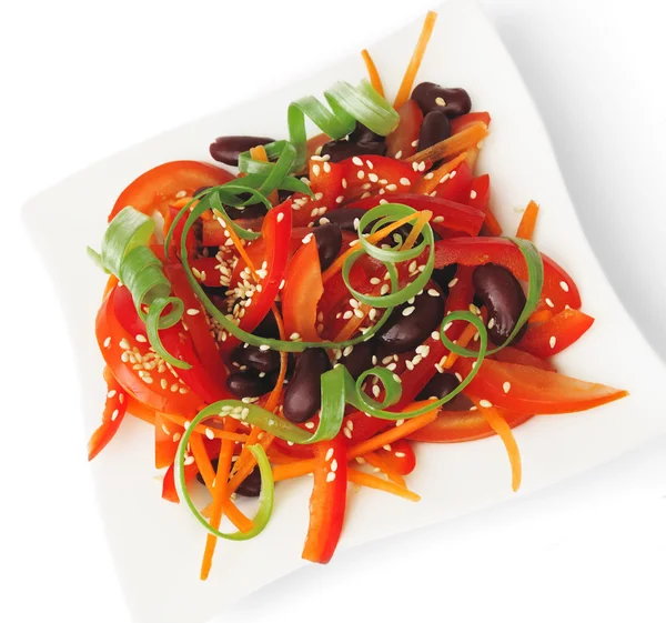 stock image A salad of tomatoes, sweet peppers, red beans, carrots with sesame