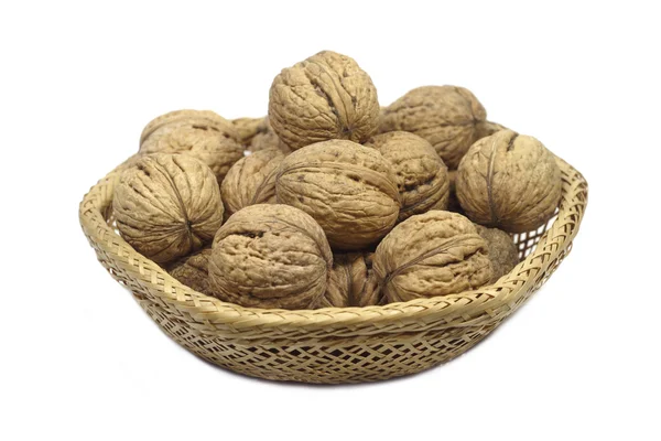 Walnuts in a straw vase isolated on white — Stock Photo, Image