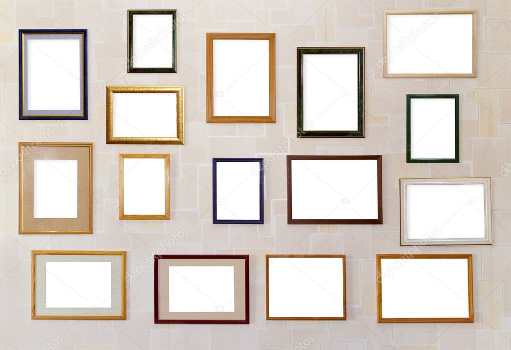 Many various photo frames hang on a wall.