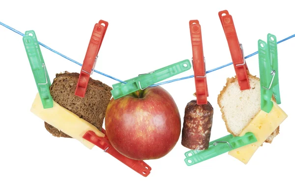 Cheese, bread, sausage and apple hang on a rope — Stock Photo, Image